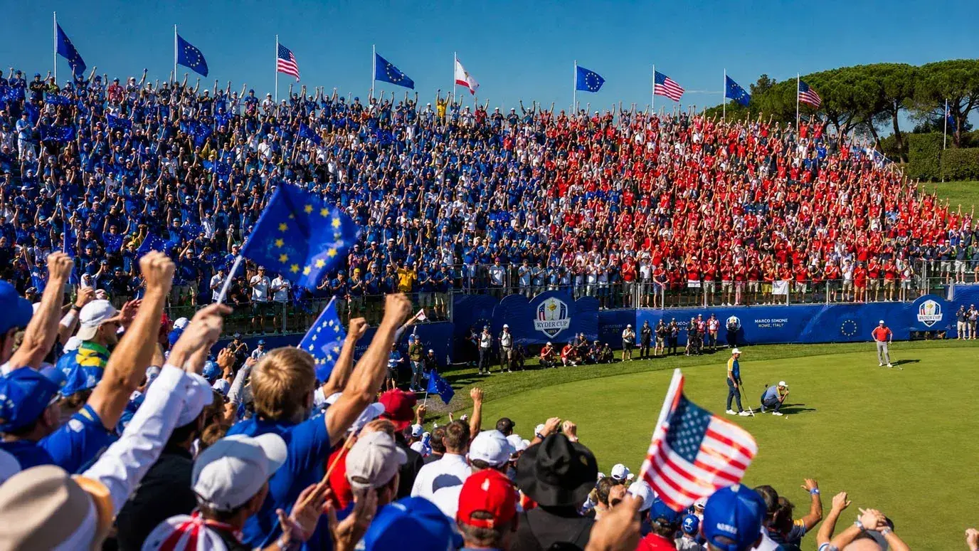 Passionate gallery cheering at a Ryder Cup match with European and American flags